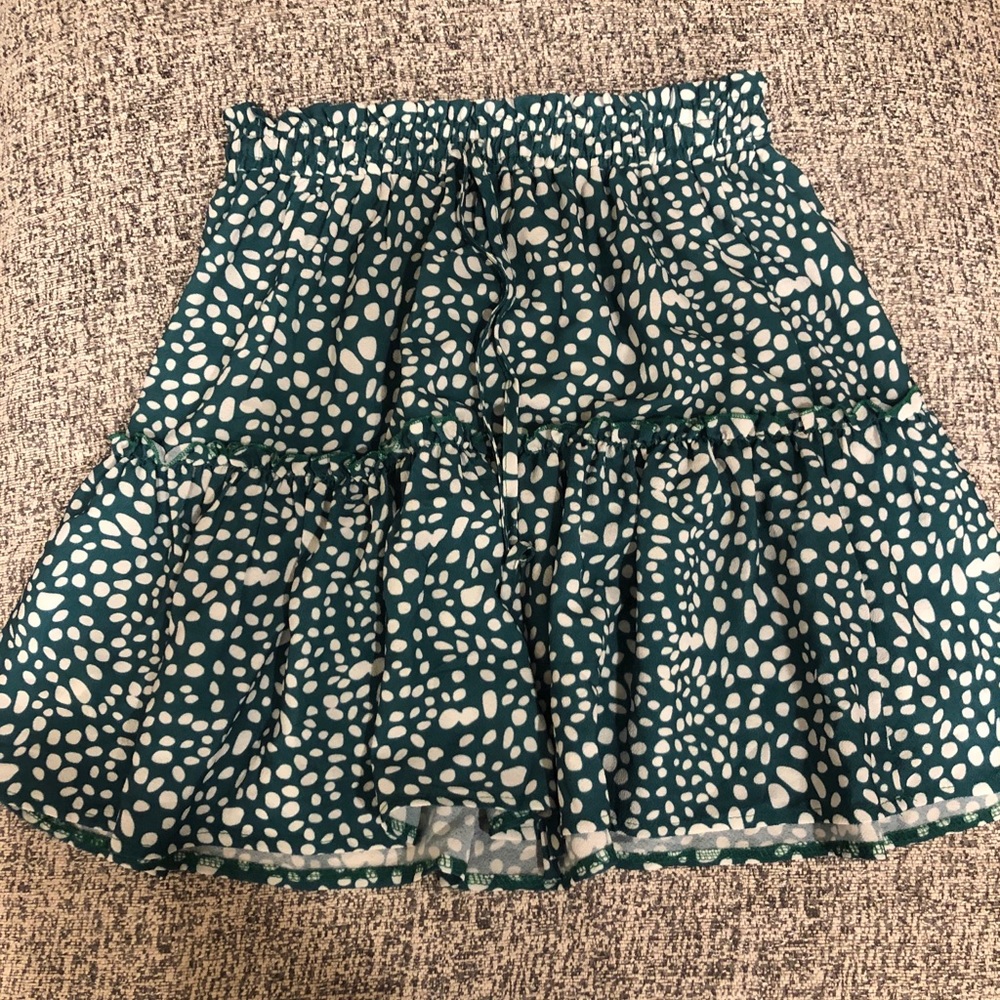 Green ruffled skirt with white polka dots